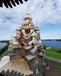 Exterior of temple by building against sky