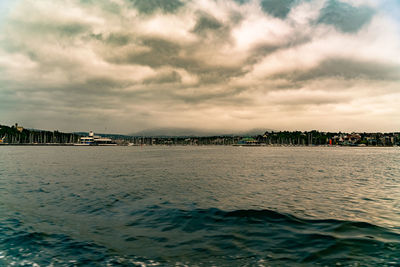 Scenic view of sea against sky in city