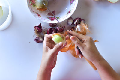 Midsection of woman holding apple on table