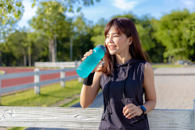 Portrait of smiling young woman standing outdoors