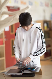 Teenage boy reading book