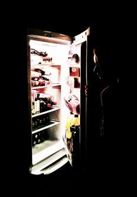 Rear view of woman in dark room