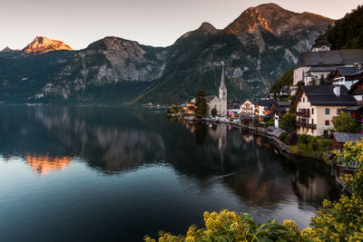 Scenic view of village by a lake against mountains