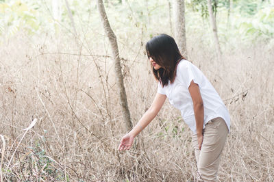 Side view of woman standing on field