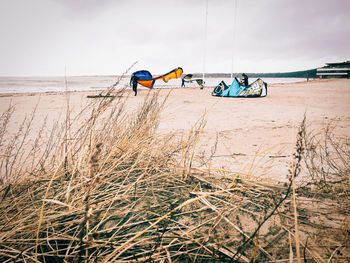 Bicycles on beach against sky