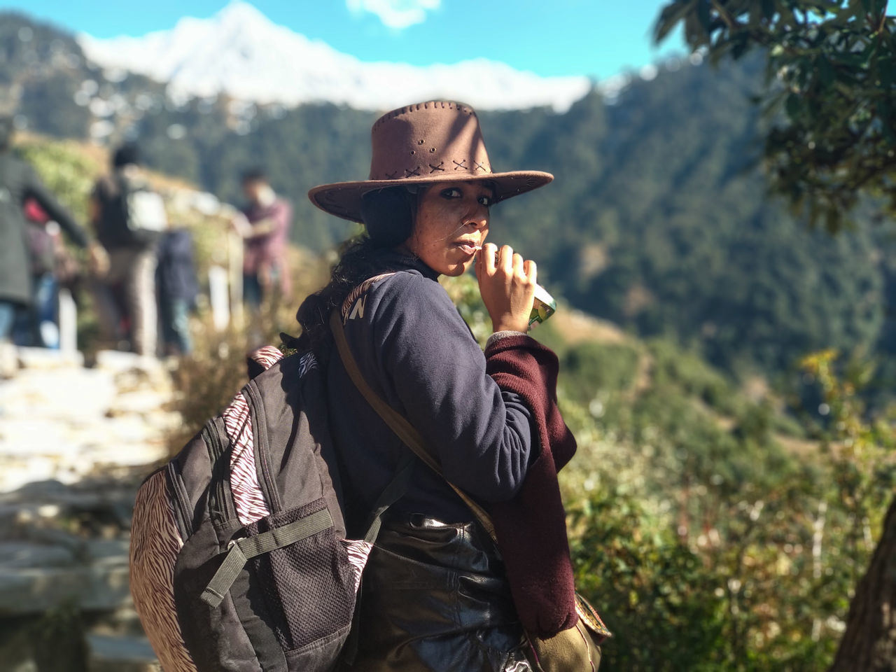 hat, one person, clothing, leisure activity, focus on foreground, real people, lifestyles, day, casual clothing, men, nature, standing, three quarter length, sunlight, young adult, waist up, adult, activity, young men, outdoors