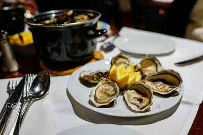High angle view of oysters in plate on restaurant table