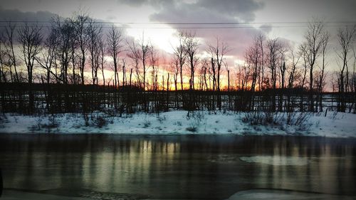 Scenic view of snow covered landscape at sunset