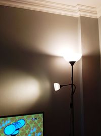 Low angle view of illuminated lamp hanging on ceiling