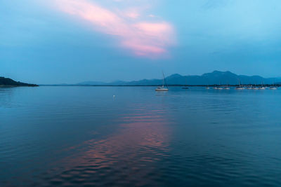 Scenic view of prien am chiemsee lake against cloudy sky during sunset