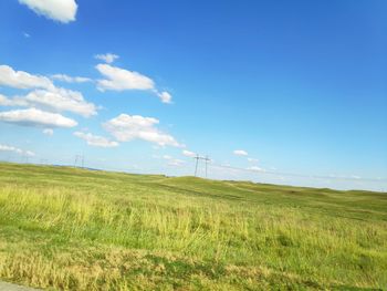 Scenic view of field against blue sky