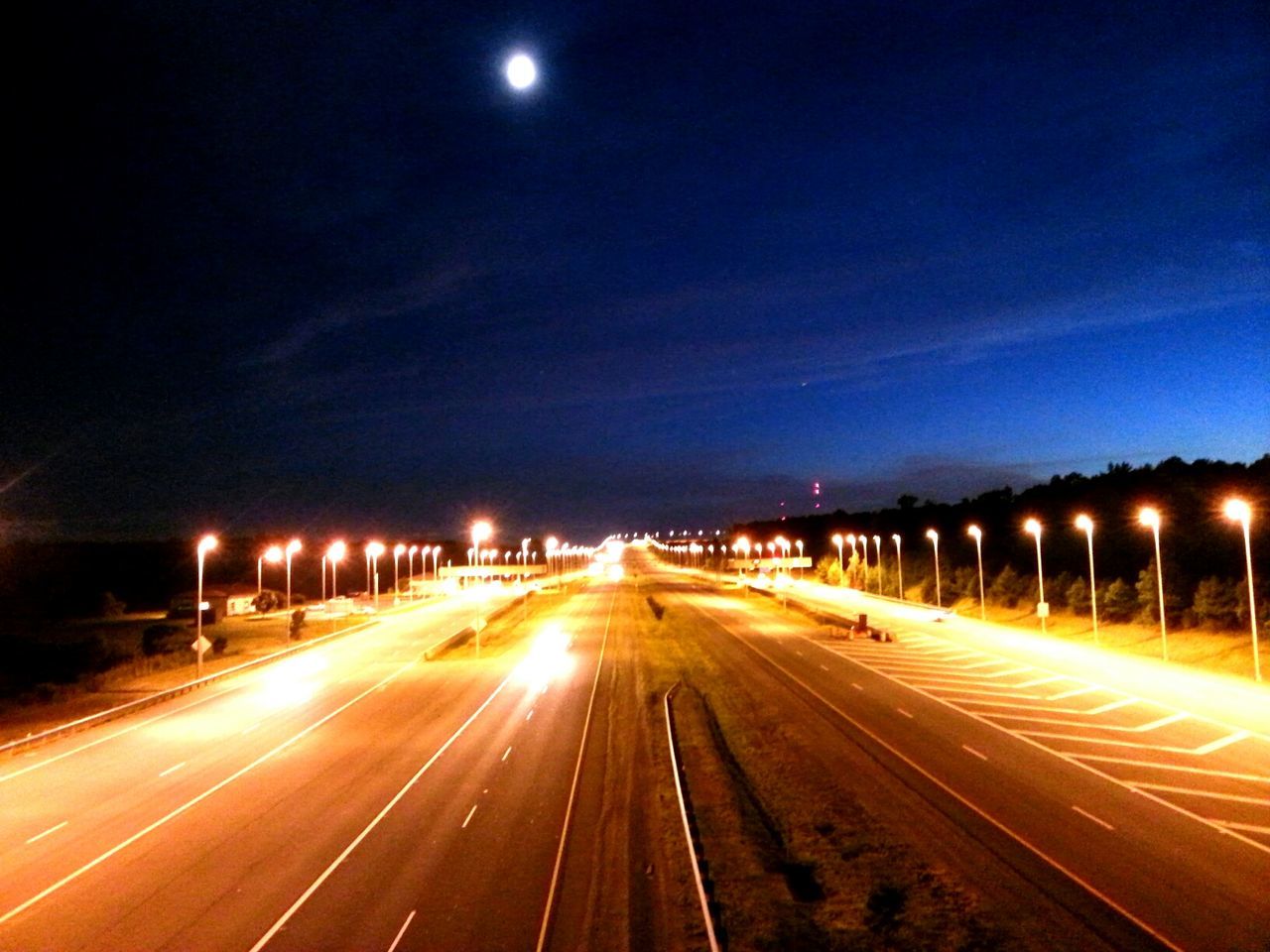 illuminated, night, transportation, long exposure, light trail, road, speed, motion, the way forward, street light, highway, diminishing perspective, road marking, blurred motion, sky, vanishing point, street, on the move, light - natural phenomenon, lighting equipment