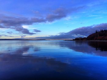 Scenic view of lake against cloudy sky