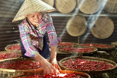 Full length of woman standing at market stall