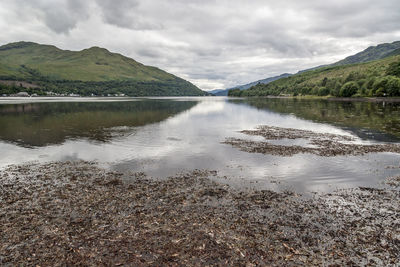 Scenic view of lake and mountains against sky