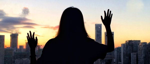 Silhouette of woman at sunset