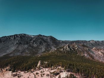 Scenic view of rocky mountains against clear blue sky