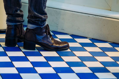 Low section of woman on tiled floor