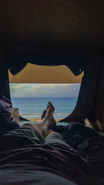 Low section of man relaxing in sea