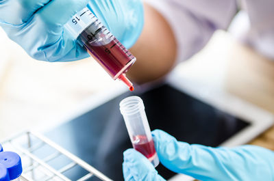 Cropped hands of scientist examining chemical