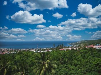 High angle view of townscape by sea against sky