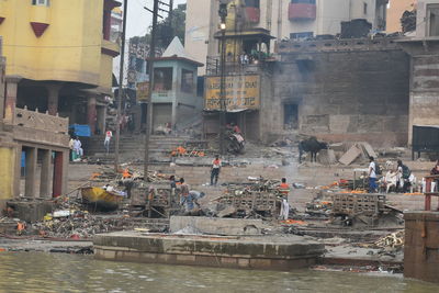 People in front of buildings in city