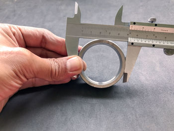 Cropped hand measuring hole with ruler