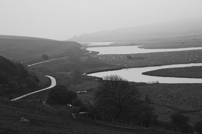 High angle view of road by land against sky