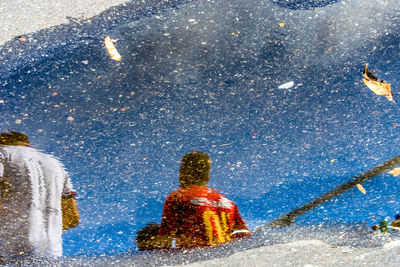 Supporters of the esporte clube bahia football team.  reflection of the water.