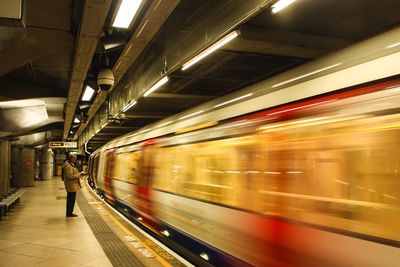 Blurred motion of train at railroad station