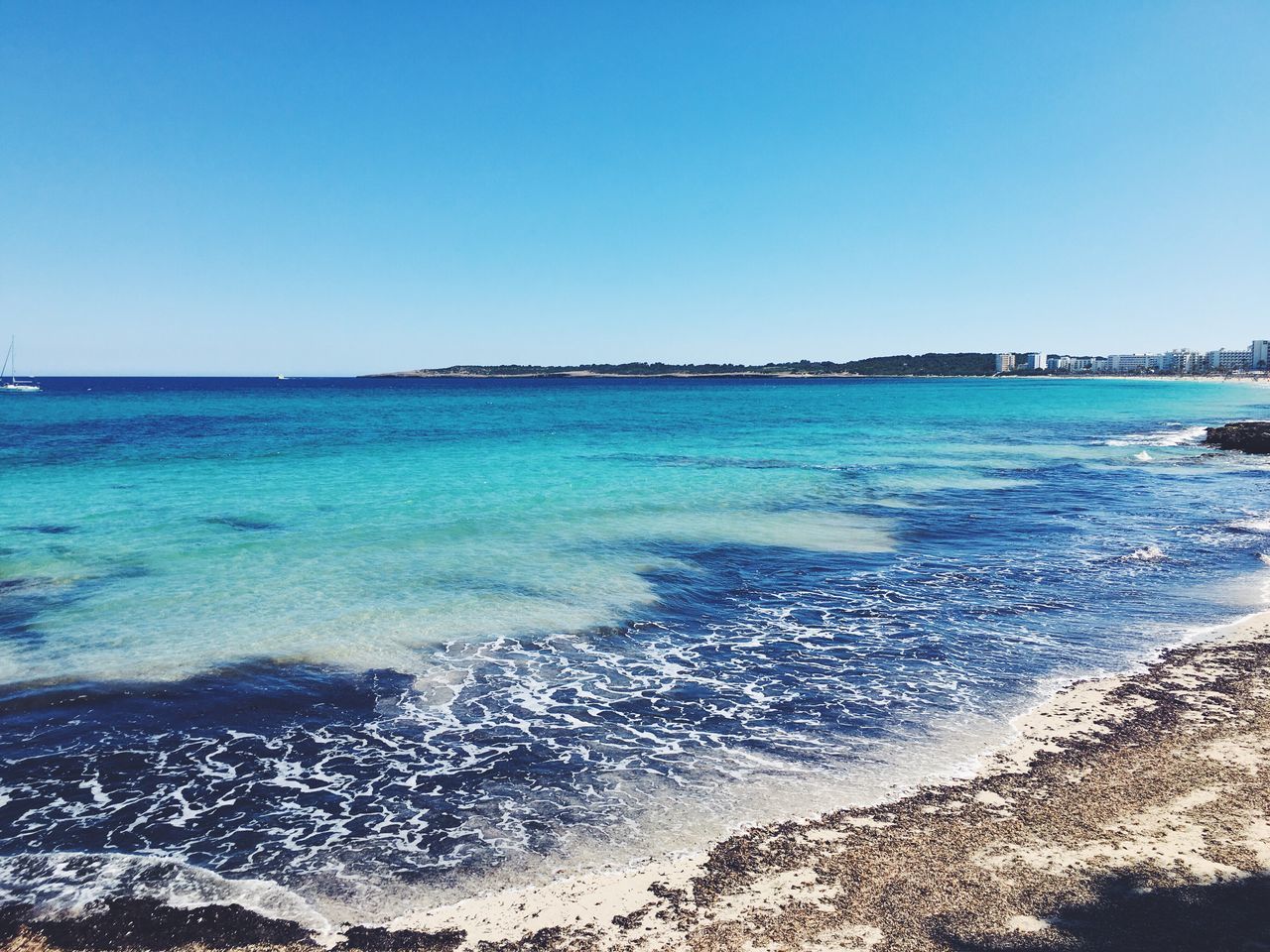 sea, water, clear sky, beach, blue, scenics, horizon over water, shore, beauty in nature, tranquil scene, tranquility, wave, nature, coastline, idyllic, day, seascape, sky, outdoors, non-urban scene, remote, travel destinations, no people, vacations, rippled, tourism, calm, ocean