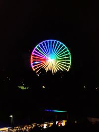 Illuminated ferris wheel at night