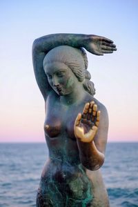 Statue of woman in water