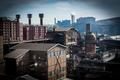 High angle view of buildings in city against sky