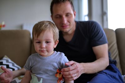 Portrait of happy family sitting on sofa at home