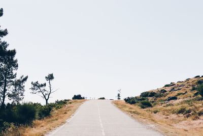 Low angle view of country road passing through landscape