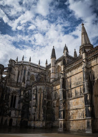 Batalha monastery against cloudy sky