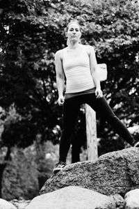 Full length of woman standing on tree