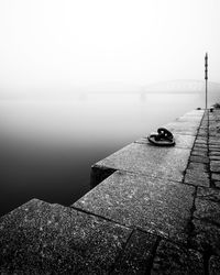 Pier over lake against sky