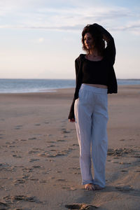 Young woman standing at beach