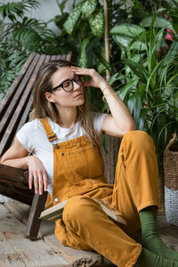 Thoughtful woman with book relaxing at home