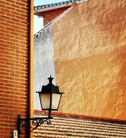 Low angle view of street light against building