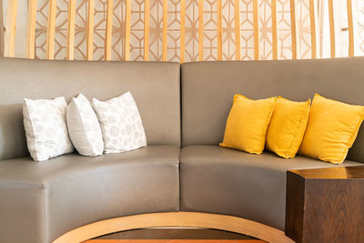 Close-up of sofa on table against wall at home