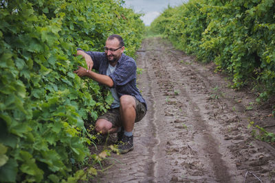 Full length of man climbing in farm