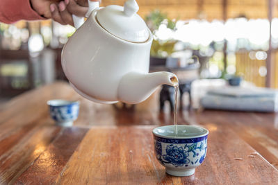 Midsection of coffee cup on table