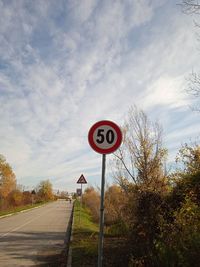 Road sign against sky