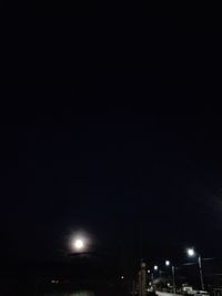 Low angle view of illuminated street light against sky at night