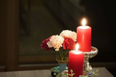 Close-up of illuminated tea light candles on table