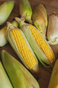 Top view of fresh ear of corn lay down on the table ready to prepare to make healthy corn recipe.