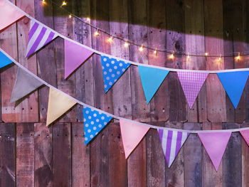 Various patterned triangular flags on wooden planks background